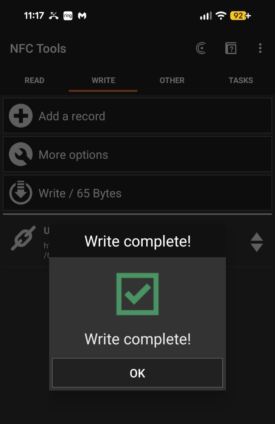Phone writing the review link to an NFC stand